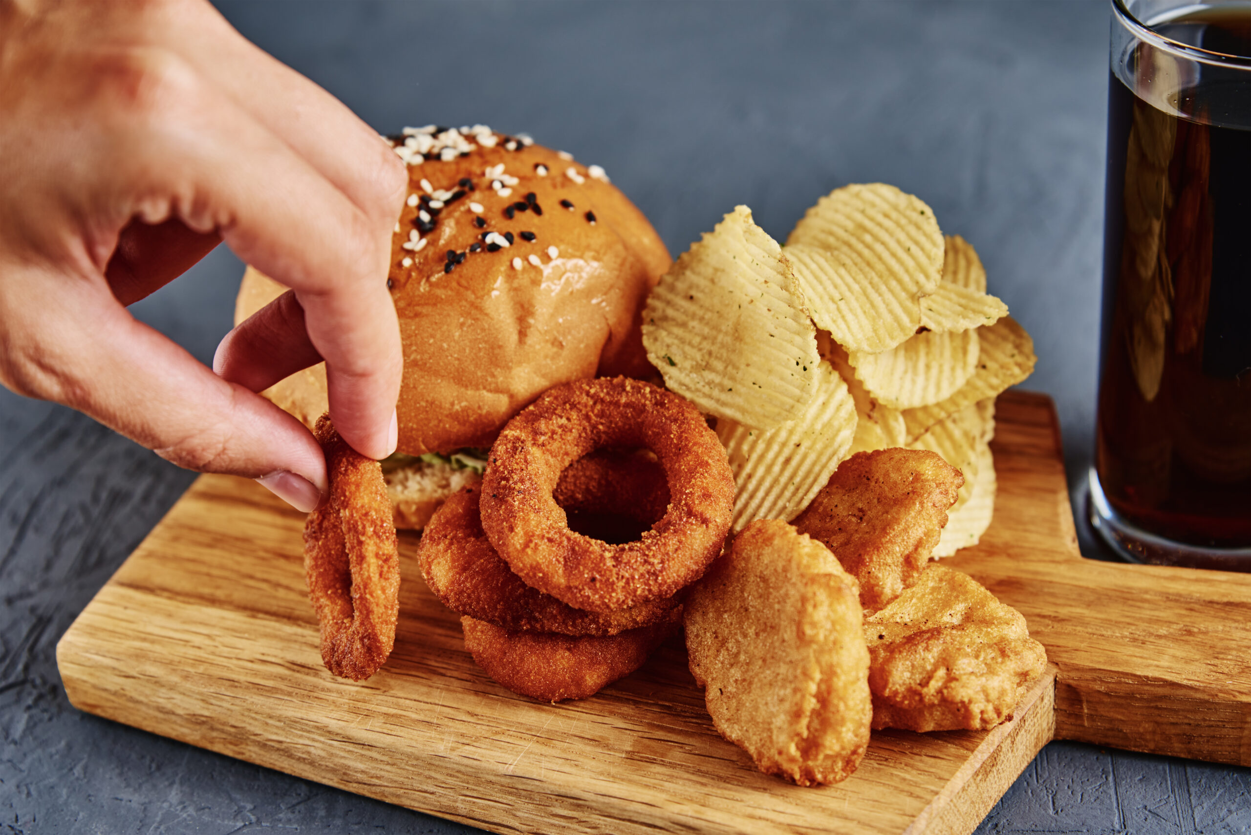 Unhealthy products and junk food. Different types of fastfood and snacks on the table, closeup. Takeaway food